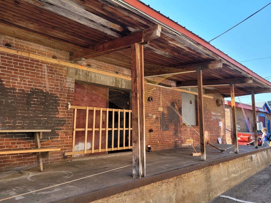 multiple looms warped together and wrapped around the deck of a warehouse