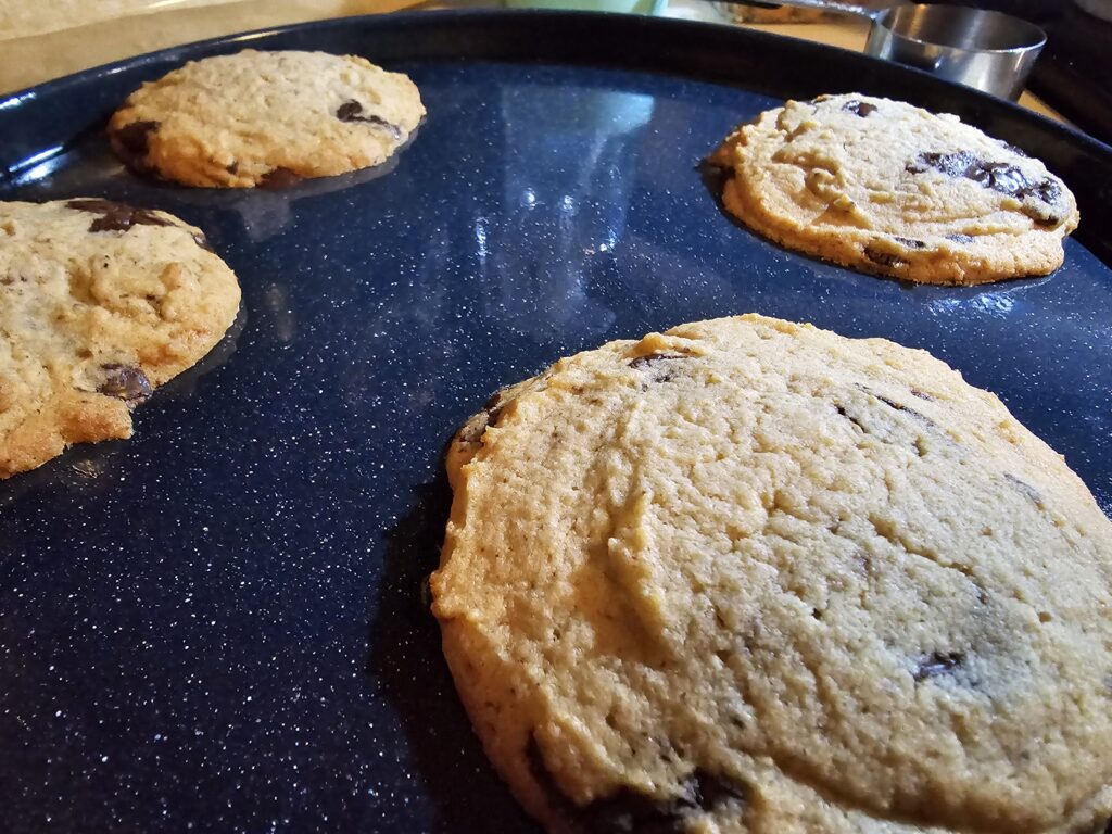 a photograph of large, thick, chocolate chip cookies.