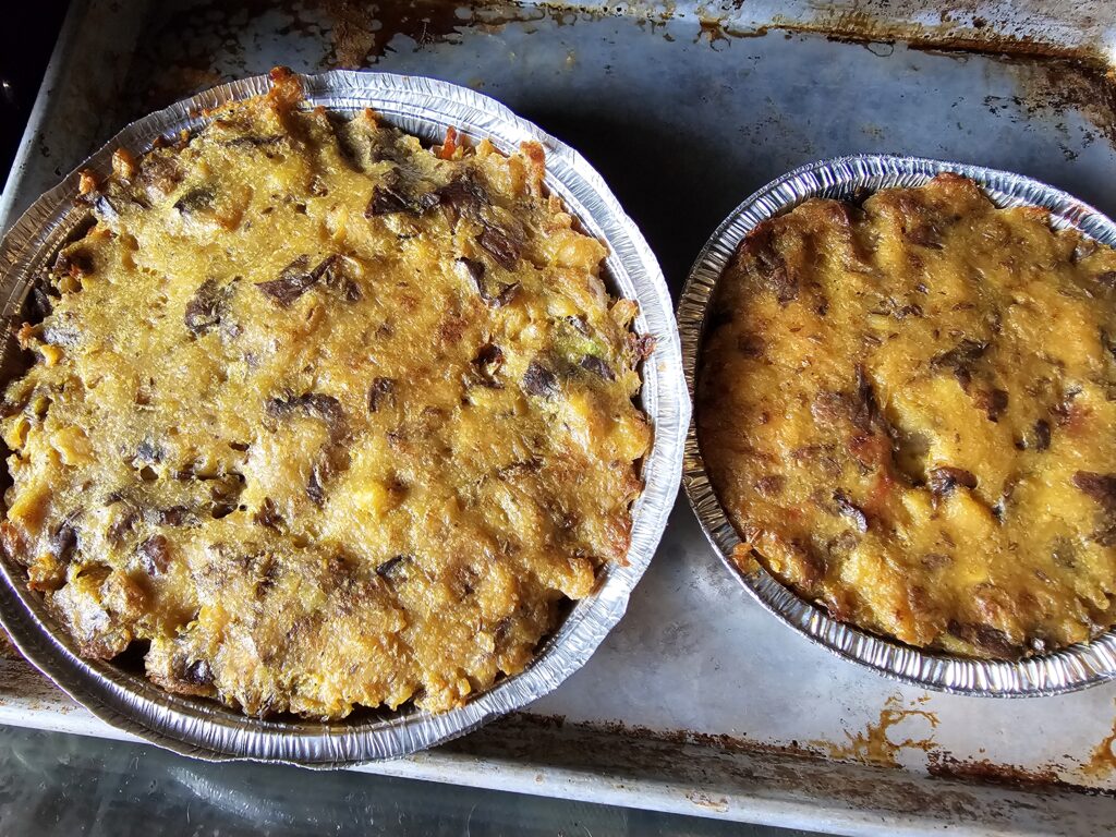 The finished vegan samosa pies with smooth, golden potato mash toppings.